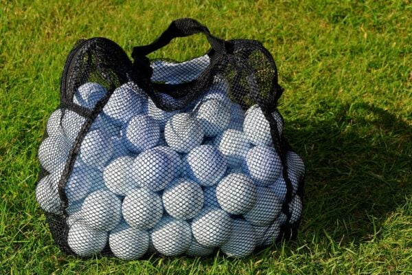 Picture of a sack of golf balls on grass