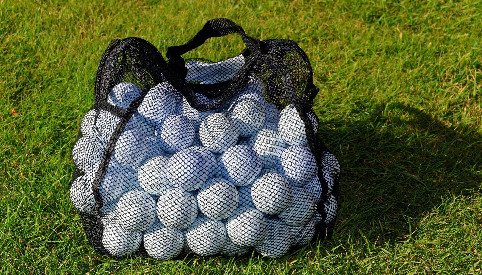 Picture of a sack of golf balls on grass