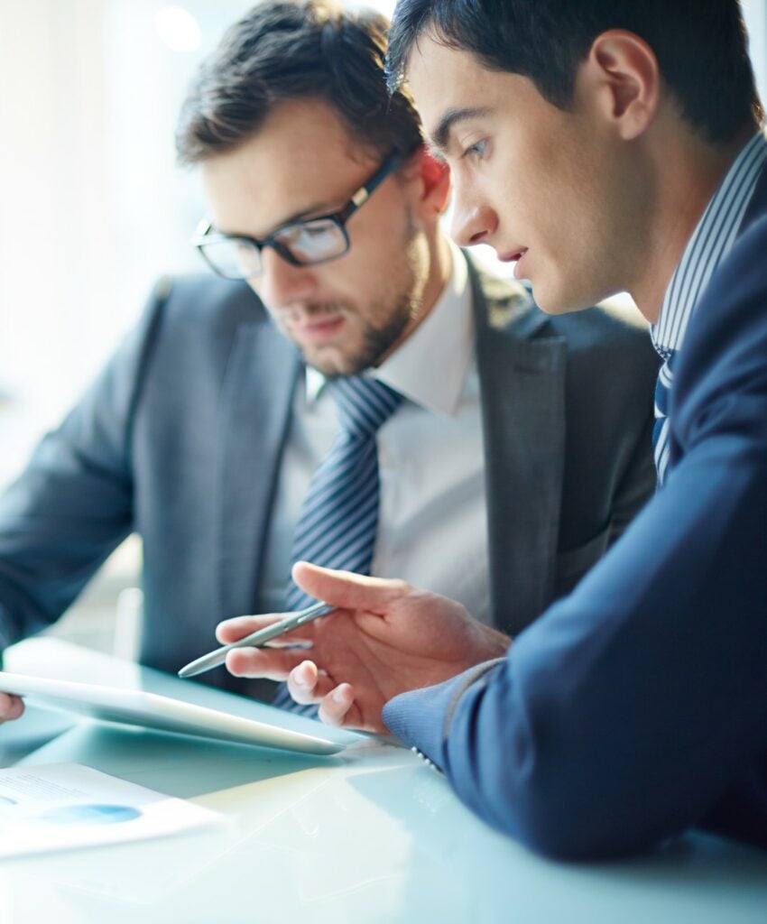 Picture of businessmen using a tablet in a business meeting