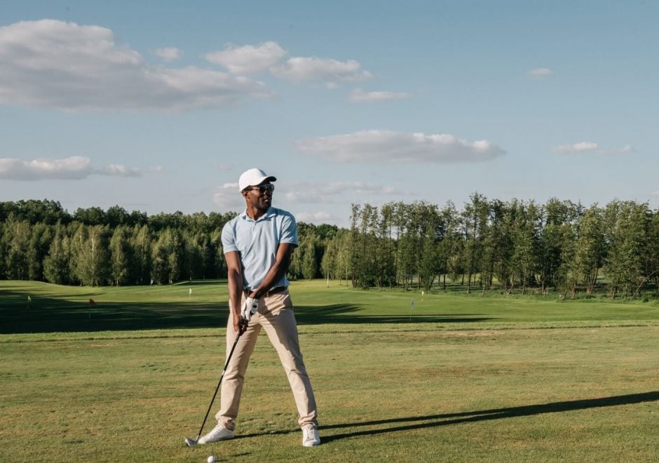 Picture of a man about to swing at a golf ball on a golf course Picture of a man about to swing at a golf ball on a golf course